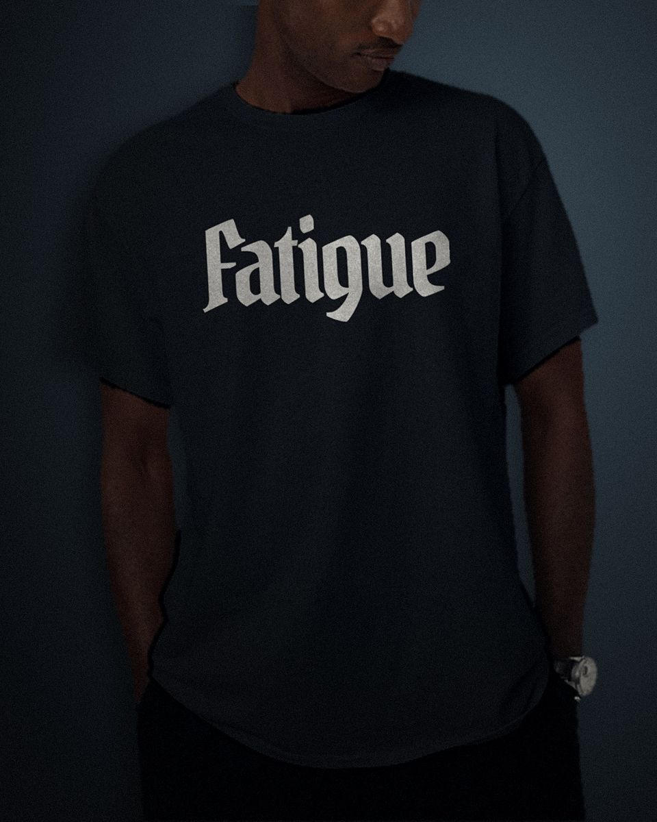 Condensed Headline tee in black, white full chest print, worn by a model