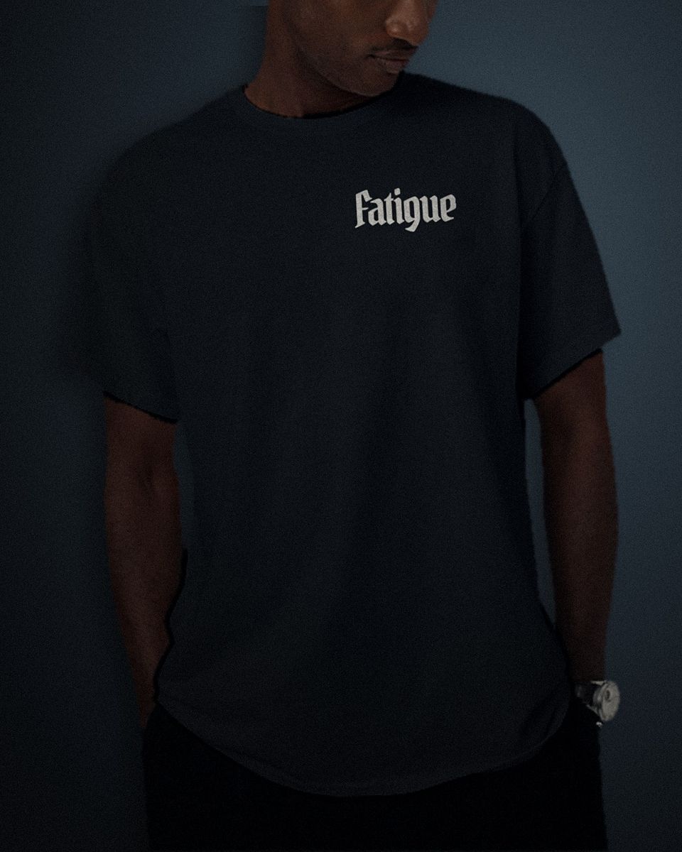 Condensed Headline tee in black, white left chest print, worn by a model