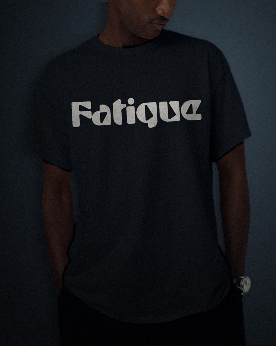 Heavy Block tee in black, white full chest print, worn by a model
